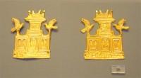 26. Gold cut-outs in the shape of a tripartite shrine crowned by horns of consecration with perched birds. 