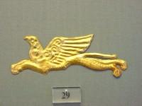 29. Gold cut-out in the shape of a griffin.
