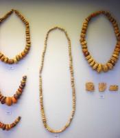 100, 101, 513, 758. Beads and plaques of amber necklace. Graves III and V.