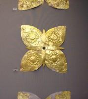 86. Gold floral ornaments of overlapping sheets, perhaps the head of elaborate pins.