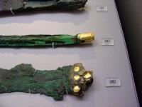 482, 403, 429. Bronze dagger with ivory revetment on the shoulder and gold-plated nails, fragment of a bronze staff with a gold ring at the hilt and a bronze knife. Tomb IV