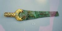 294. Fragment of a bronze sword with the hilt and shoulder decorated in the cloisonné technique.