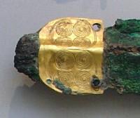 726. Χάλκινο ξίφος τύπου Α με χρυσή επικάλυψη λαβής διακοσμημένη με ανάγλυφες σπείρες, που στερεώνεται με επίχρυσους ήλους.