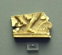 9562. Fragment of an ivory plaque with relief scene of men and a bull