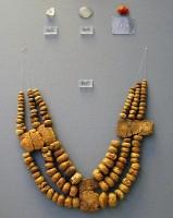 8657. Remarkable triple-strand necklace with amber beads and plaques, imported from north-western Europe. Grave Omicron