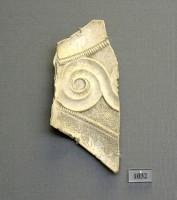 1032. Curved ivory inlay plaque decorated with relief spirals.