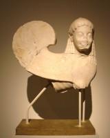2891. Statue of a sphinx, originally crowning a grave stele. Island marble from the Cyclades. Attic work around 550 B.C. 