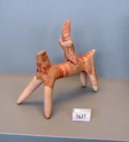 7637. Clay model of a horse and rider.