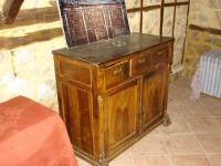 Dolgiras Mansion: Vintage chest of drawers with a painting of the mansion's interior, salvaged from the debris
