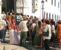Our Lady of Tinos: Group of pilgrims at the entrance carrying huge candles