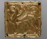 Chryselephantine Statues: 10.  Square plate of gold with relief griffin riveted on a bronze plaque, which decorated the figure’s garment as breast jewelry.