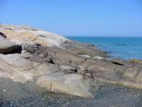 Tinos: The wind and seaswept boulders of Livada Beach on Tinos
