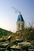 Tinos: The bell Tower of humble Zoodochos Pighi Chapel near Berdemiaros Village.