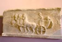 Akr 1326. Relief of a four-horse chariot and an Apobates